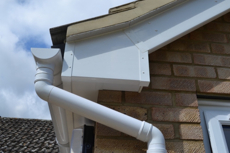 New gutters and downpipes installation in the UK by Surrey Roofers, providing effective drainage solutions and property protection.